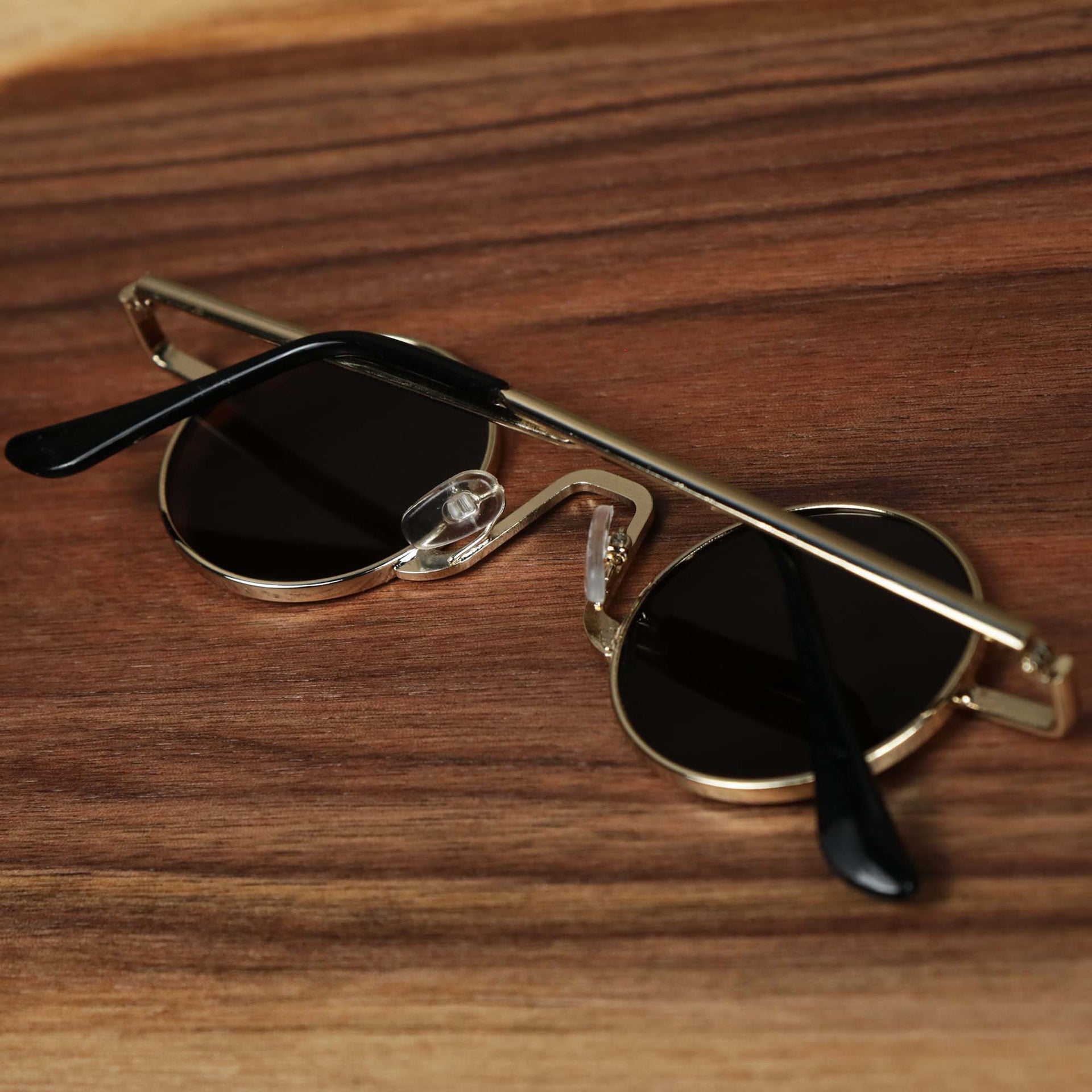 The Round Frames Brown Lens Sunglasses with Gold Frame folded up