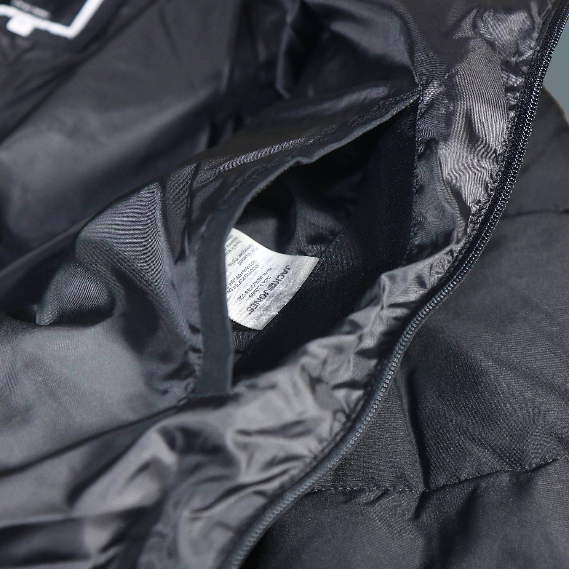 The hidden pocket on the Jack And Jones Jet Black Puffer Jacket With Hidden Pocket | Black Puffer Jacket