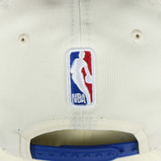 The NBA Jerry West Logo on the back of the Youth New York Knicks NBA 2022 Draft Gray Bottom 9Fifty Snapback | New Era Cream/Royal Blue