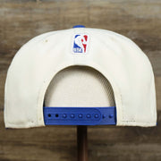 The backside of the Youth New York Knicks NBA 2022 Draft Gray Bottom 9Fifty Snapback | New Era Cream/Royal Blue