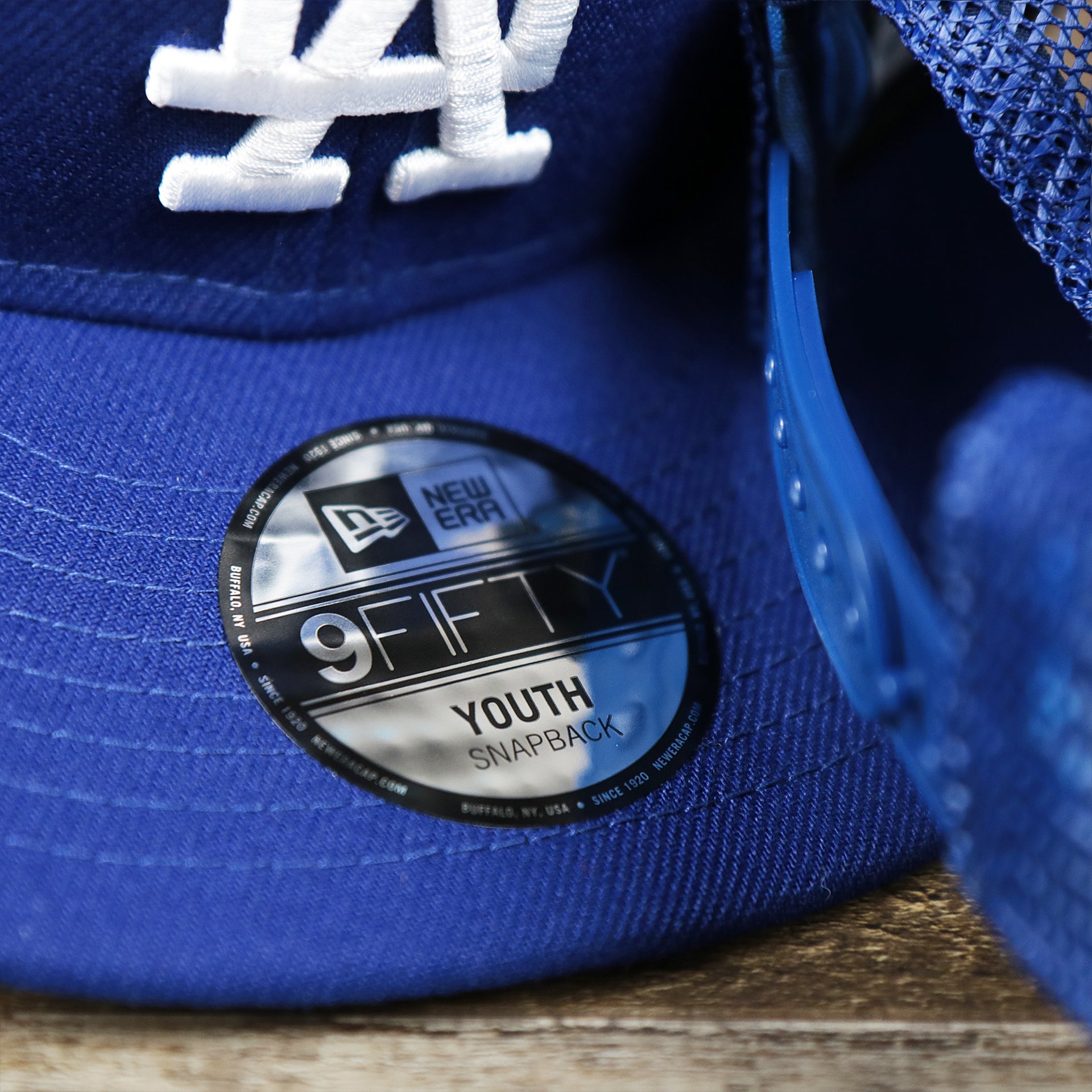 The Youth 9Fiftys Sticker on the Youth Los Angeles Dodgers MLB 2022 All Star Game Mesh Back 9Fifty Snapback Cap | ASG 2022 Royal Blue Trucker Hat