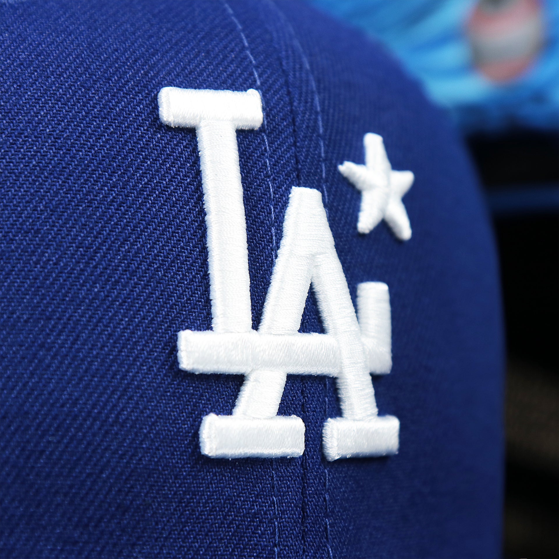 The Dodgers Logo on the Los Angeles Dodgers Metallic All Star Game MLB 2022 Side Patch 9Fifty Mesh Snapback | ASG 2022 Royal Blue Trucker Hat