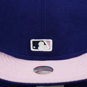 The MLB Batterman logo on the Los Angeles Dodgers Pop Sweat Pastel World Series Side Patch Fitted Cap With Pink Undervisor | Royal Blue 59Fifty Cap