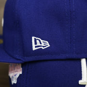 The New Era Logo on the Los Angeles Dodgers Pop Sweat Pastel World Series Side Patch Fitted Cap With Pink Undervisor | Royal Blue 59Fifty Cap