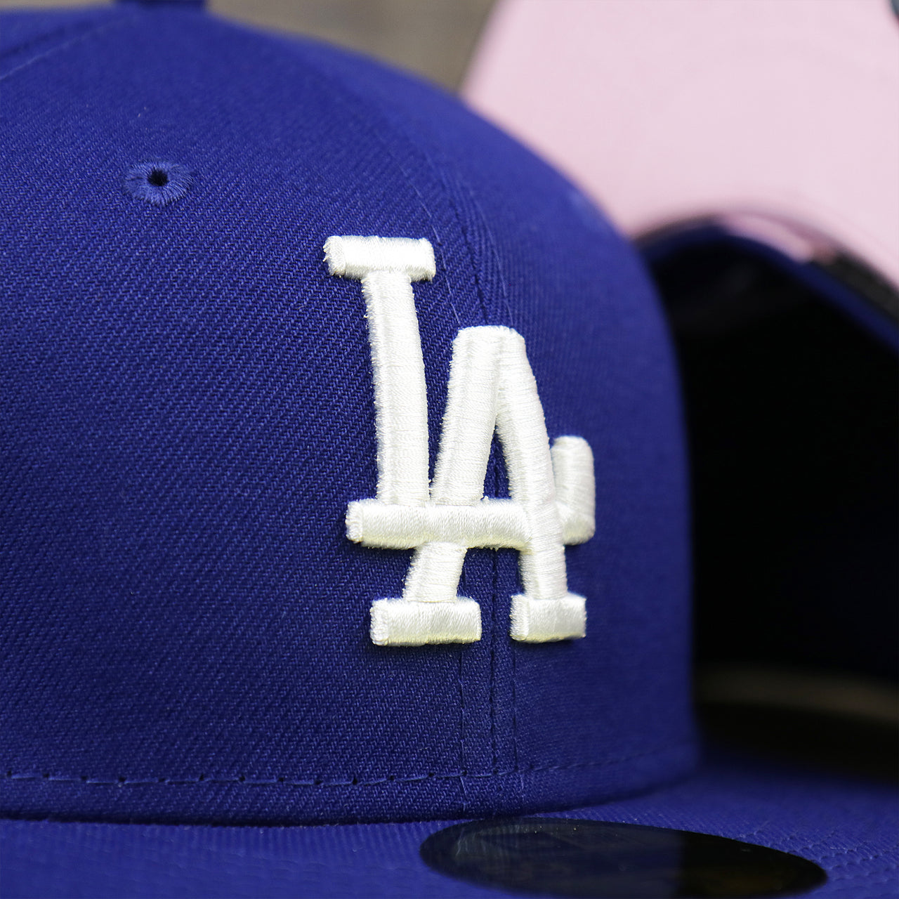 The Dodgers Logo on the Los Angeles Dodgers Pop Sweat Pastel World Series Side Patch Fitted Cap With Pink Undervisor | Royal Blue 59Fifty Cap