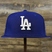 The front of the Los Angeles Dodgers Pop Sweat Pastel World Series Side Patch Fitted Cap With Pink Undervisor | Royal Blue 59Fifty Cap