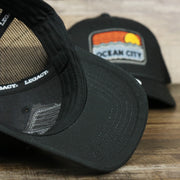 The undervisor on the Youth New Jersey Ocean City Sunset Mesh Back Trucker Hat | Black And Black Mesh Youth Trucker Hat