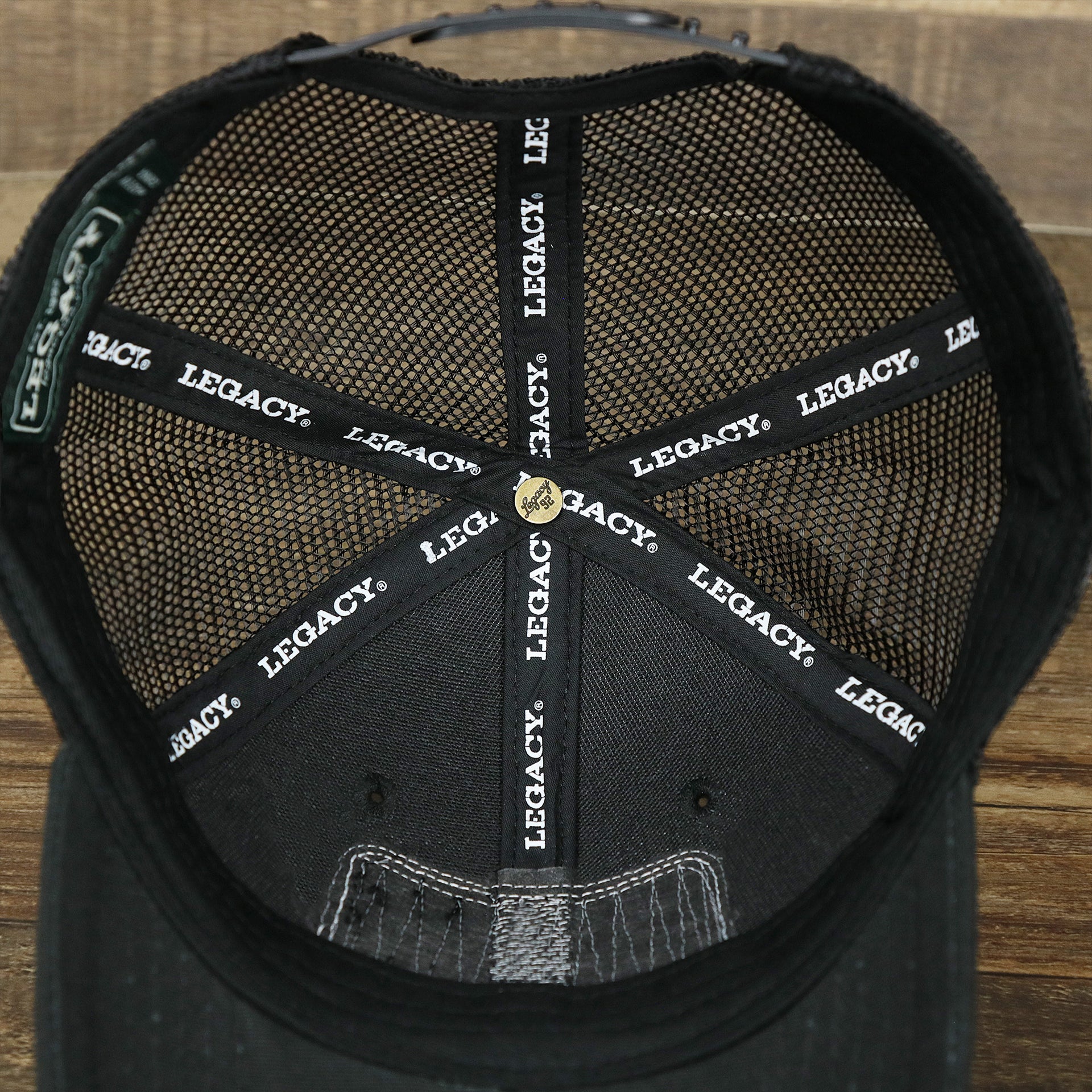 The inside of the Youth New Jersey Ocean City Sunset Mesh Back Trucker Hat | Black And Black Mesh Youth Trucker Hat