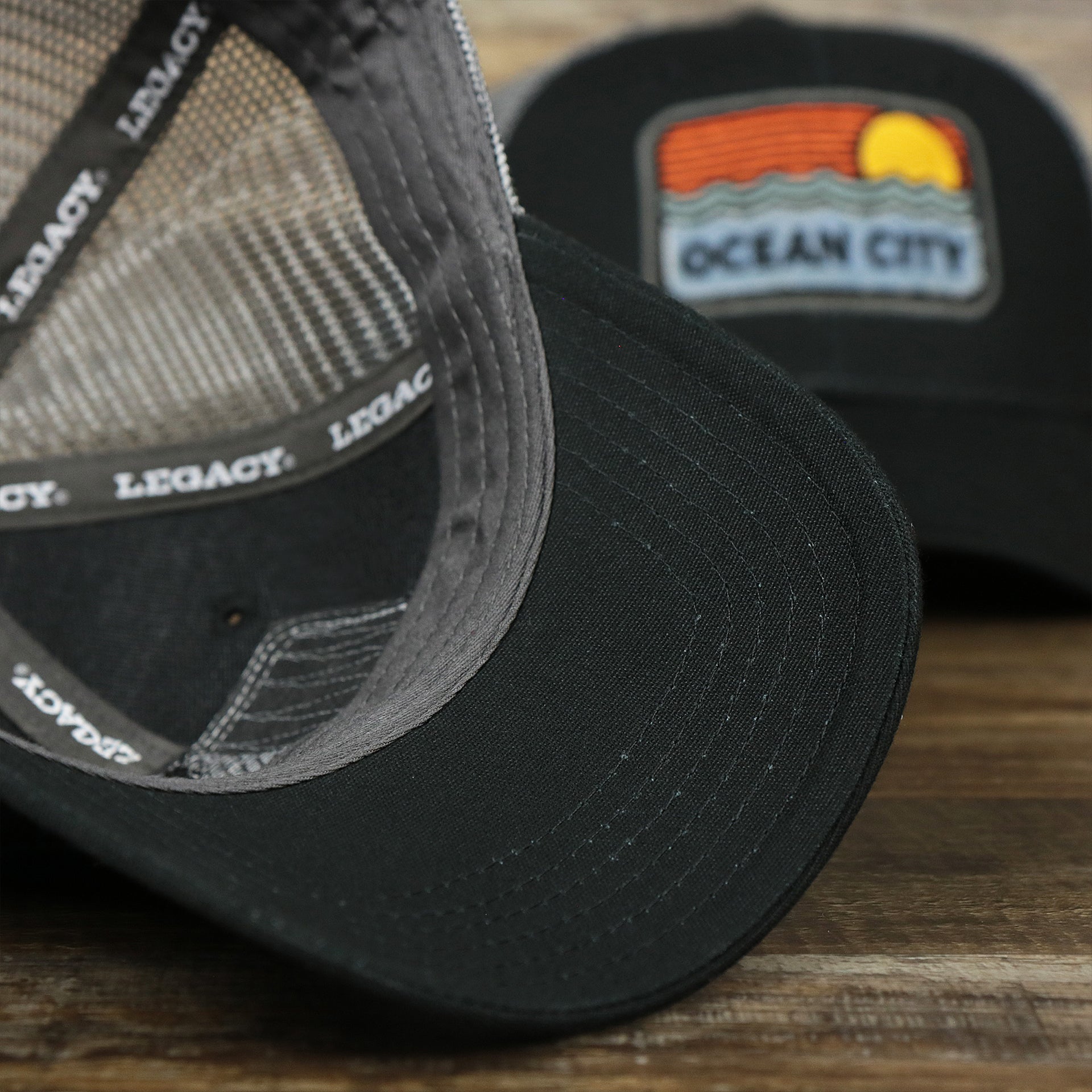 The undervisor on the Youth New Jersey Ocean City Sunset Mesh Back Trucker Hat | Black And Grey Mesh Youth Trucker Hat