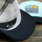 The undervisor on the New Jersey Ocean City Sunset Mesh Back Trucker Hat | Black And Grey Mesh Trucker Hat