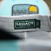 The Legacy Tag on the New Jersey Ocean City Sunset Mesh Back Trucker Hat | Black And Grey Mesh Trucker Hat