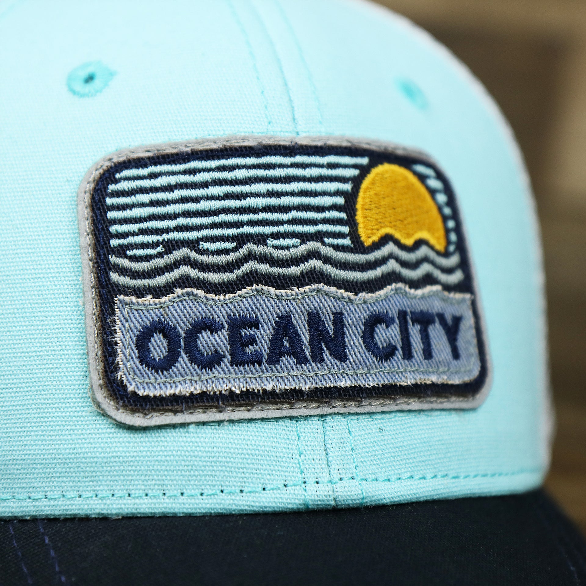 The Ocean City Sunset Patch on the New Jersey Ocean City Sunset Mesh Back Trucker Hat | Black And Grey Mesh Trucker Hat