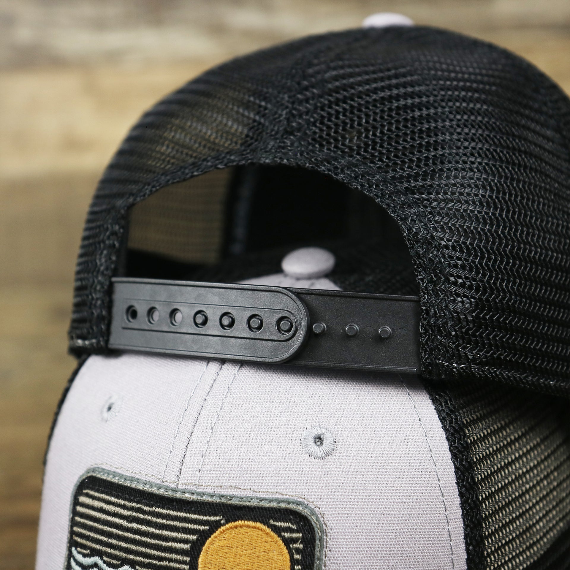 The Black Adjustable Strap on the Youth New Jersey Ocean City Sunset Mesh Back Trucker Hat | Gray And Black Mesh Youth Trucker Hat