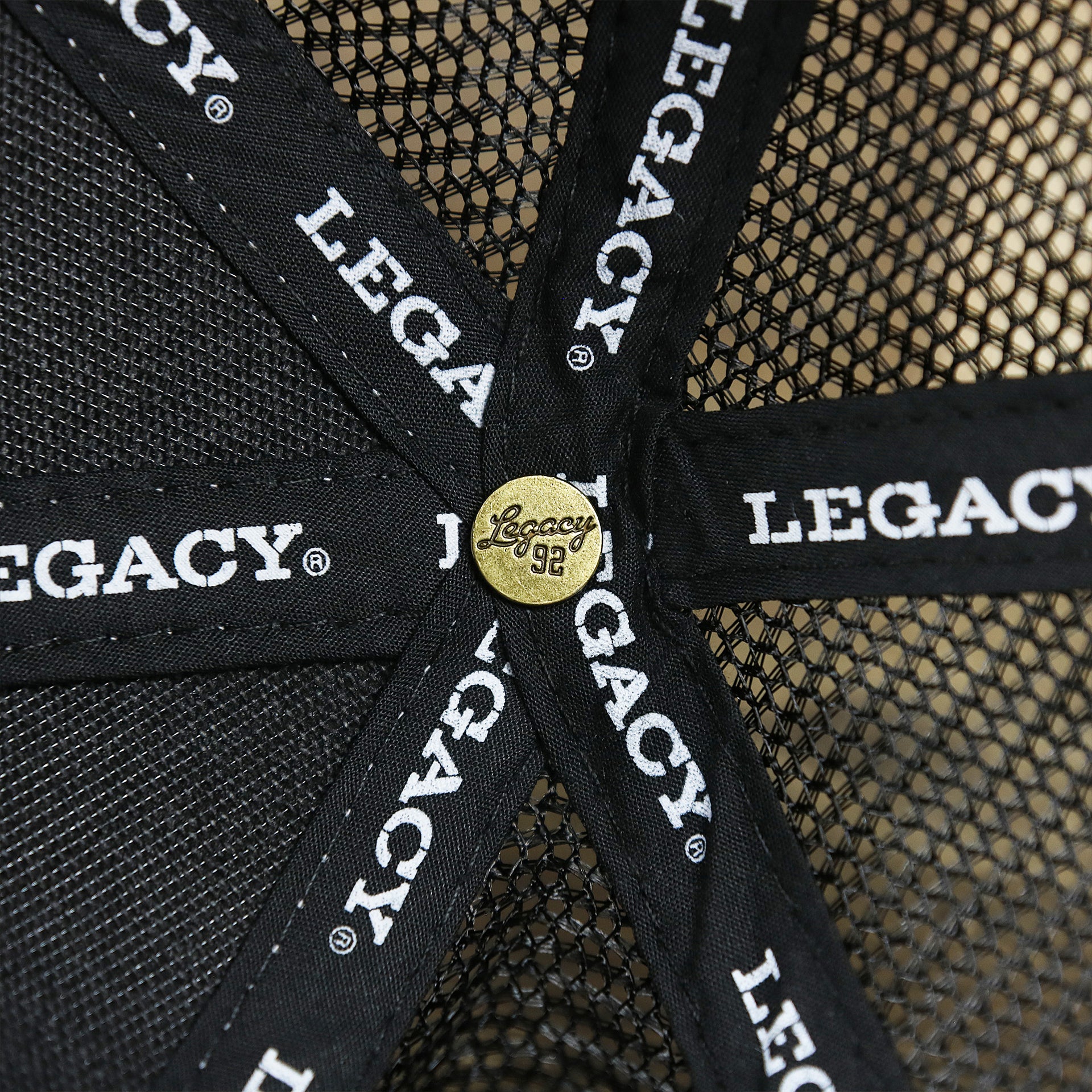 The Legacy Engraved Button on the Youth New Jersey Ocean City Sunset Mesh Back Trucker Hat | Gray And Black Mesh Youth Trucker Hat