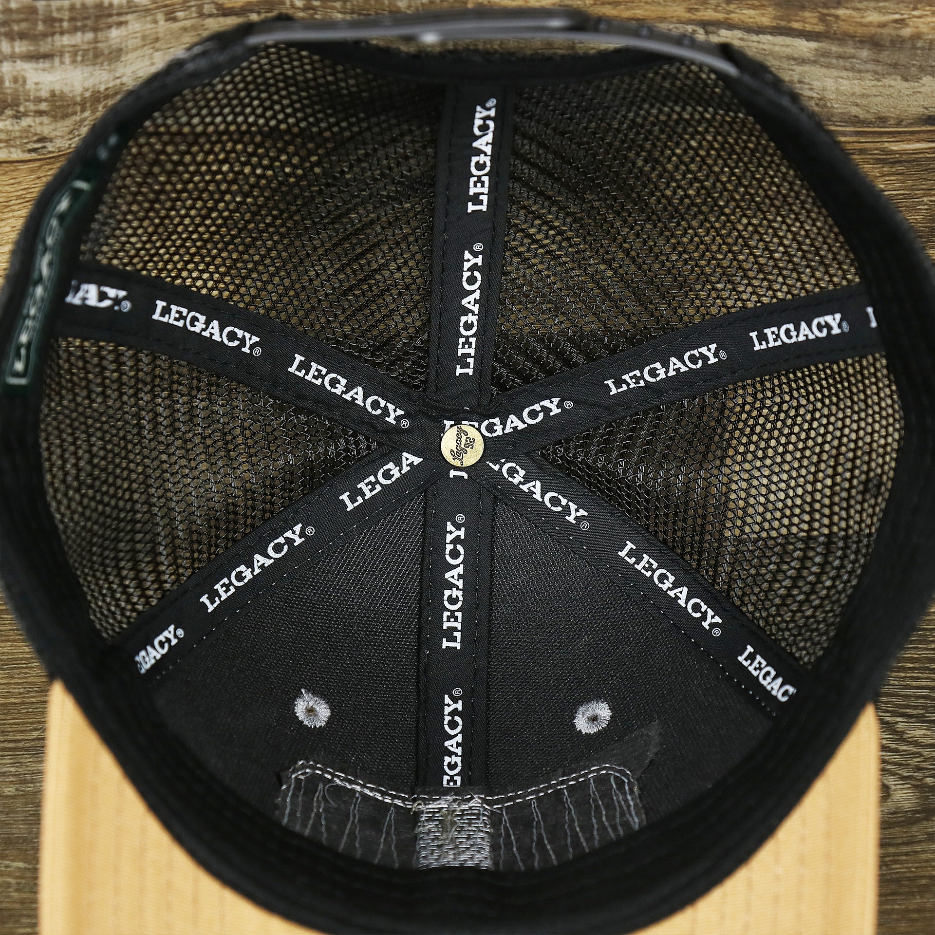The inside of the Youth New Jersey Ocean City Sunset Mesh Back Trucker Hat | Gray And Black Mesh Youth Trucker Hat