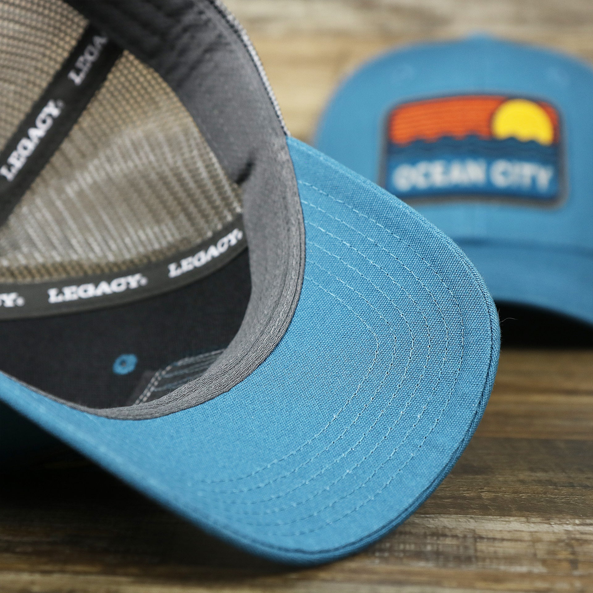 The undervisor on the Youth New Jersey Ocean City Sunset Mesh Back Trucker Hat | Marine Blue And Dark Gray Mesh Youth Trucker Hat