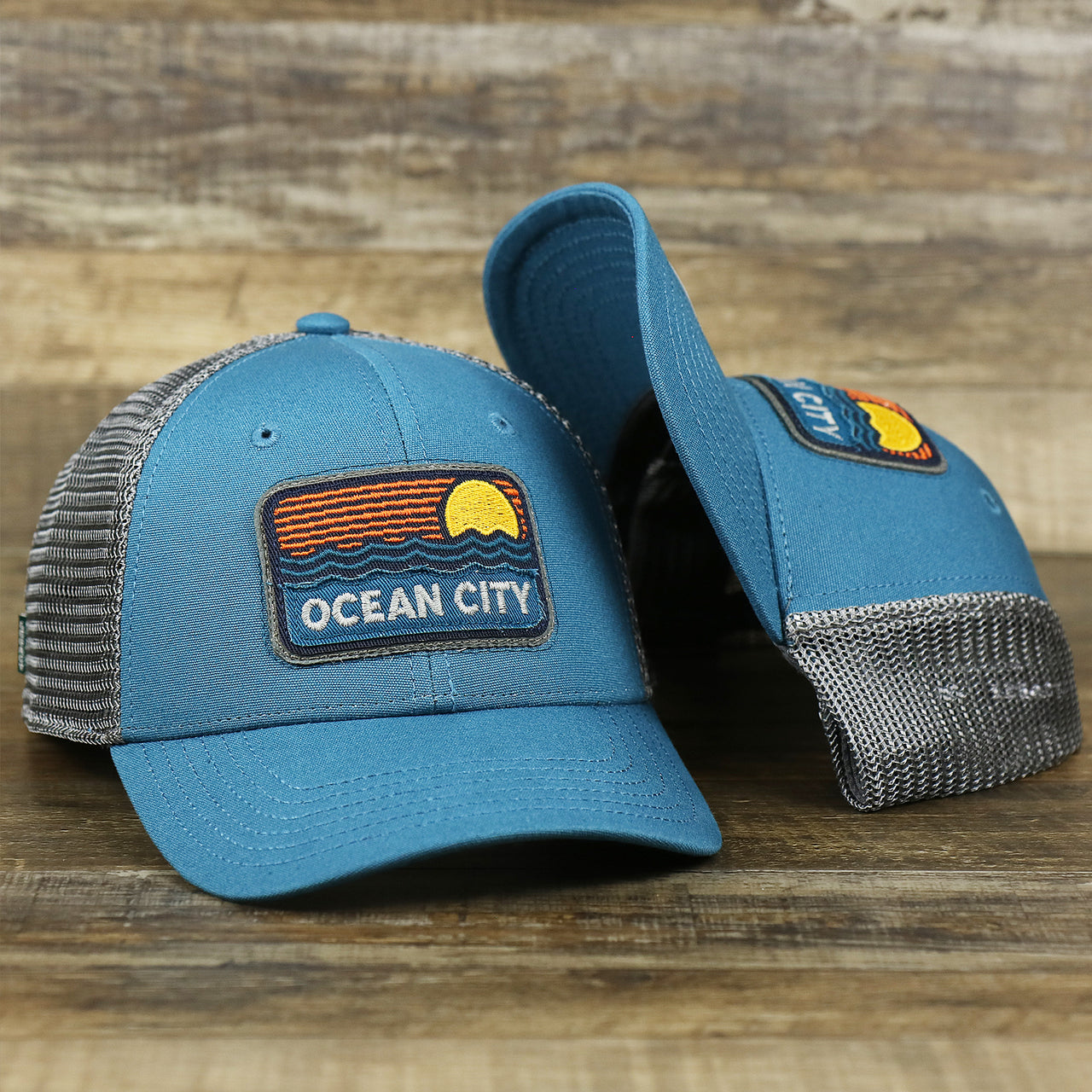 The Youth New Jersey Ocean City Sunset Mesh Back Trucker Hat | Marine Blue And Dark Gray Mesh Youth Trucker Hat