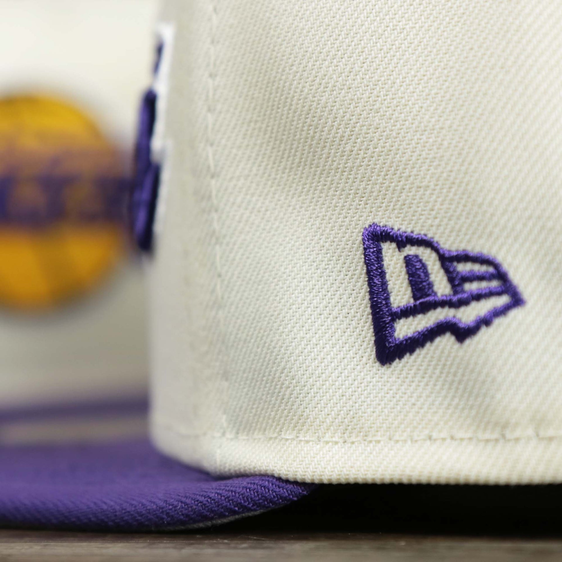 The NBA Jerry West Logo on the back of the Los Angeles Lakers NBA 2022 Draft Gray Bottom 9Fifty Snapback | New Era Cream/Purple