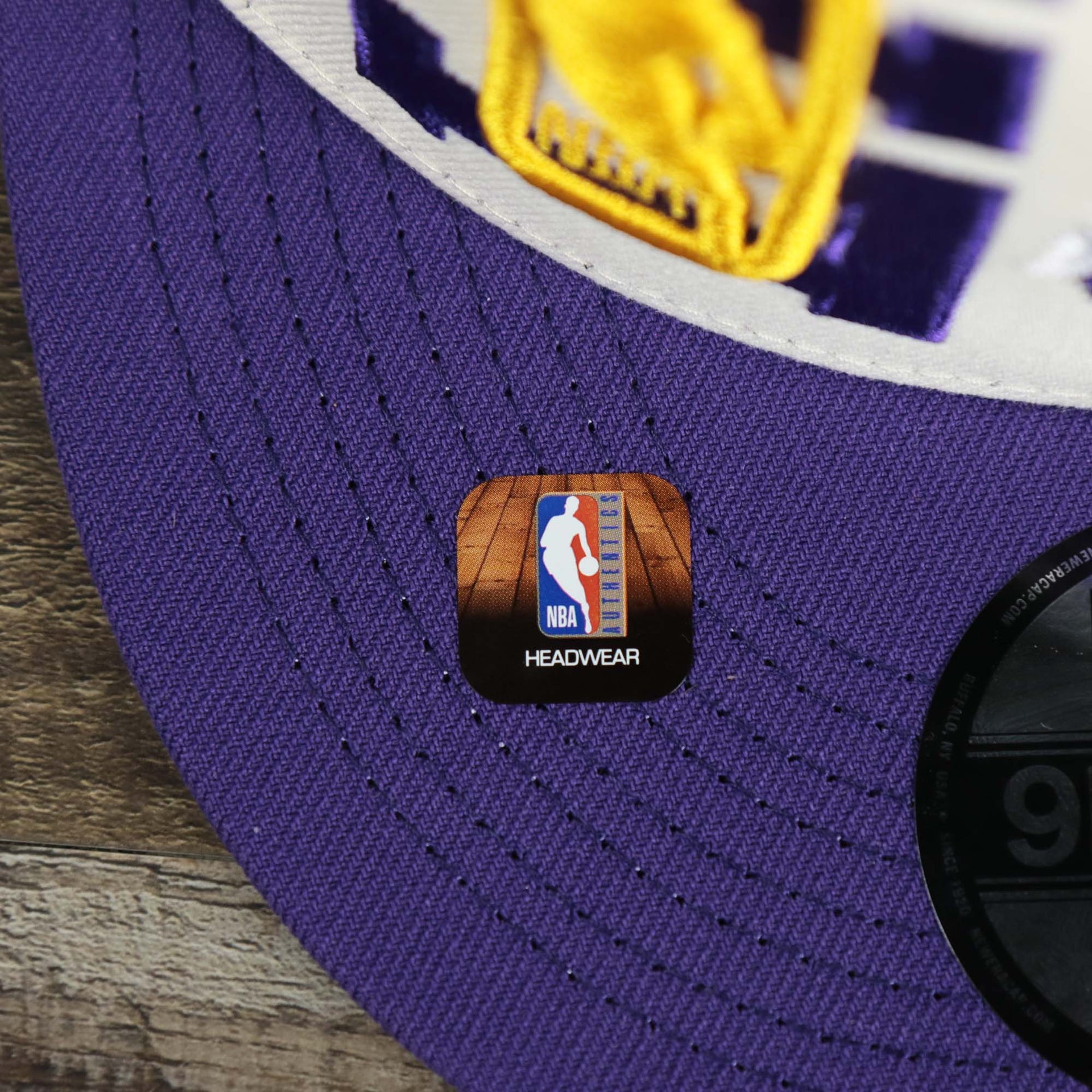 The NBA Offical Headwear Sticker on the Los Angeles Lakers NBA 2022 Draft Gray Bottom 9Fifty Snapback | New Era Cream/Purple