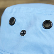 The button on the Ocean City New Jersey 1897 Bucket Hat | Light Blue Bucket Hat