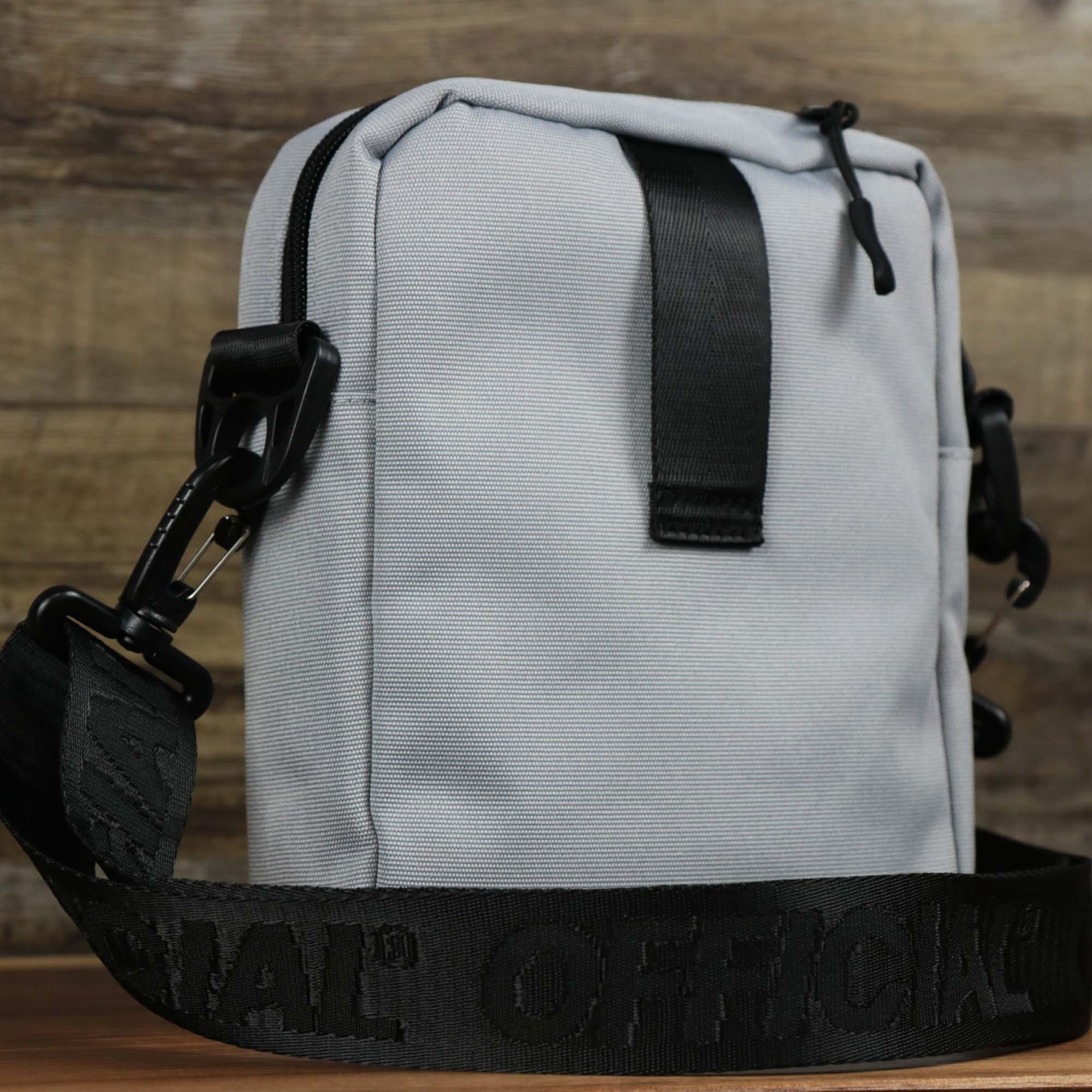 The backside of the Essential Nylon Shoulder Bag Streetwear with Mesh Pocket | Official Gray