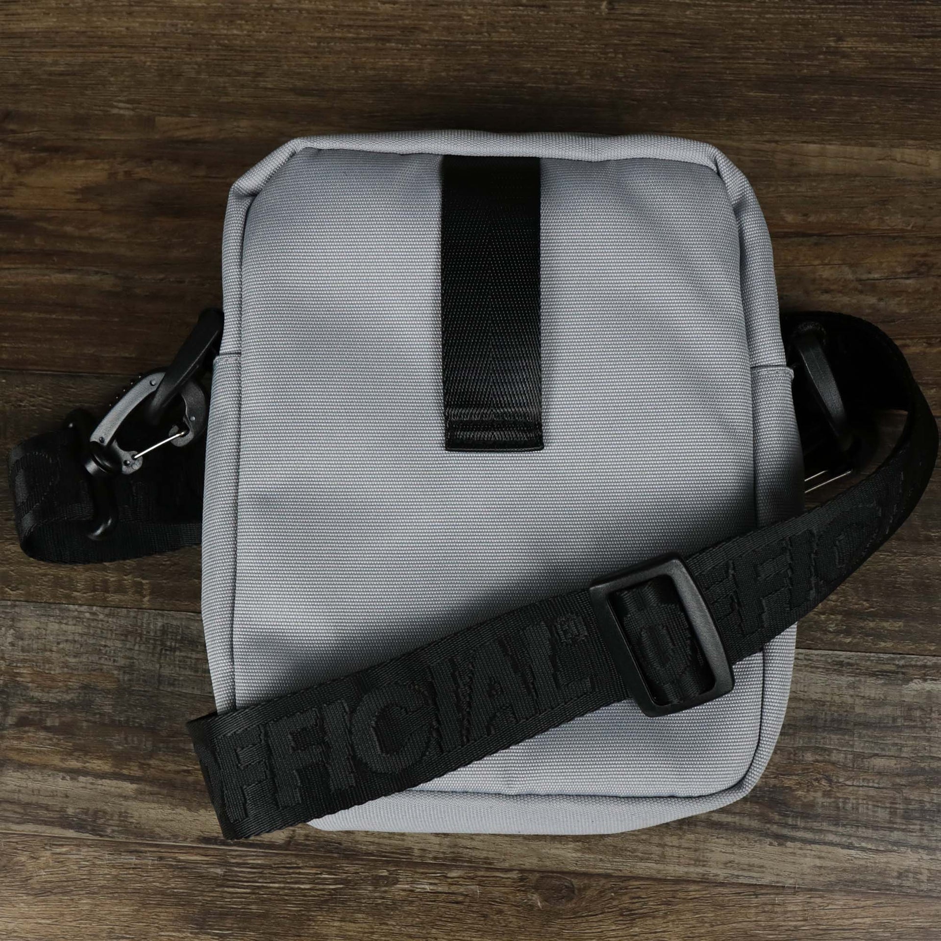 The backside of the Essential Nylon Shoulder Bag Streetwear with Mesh Pocket | Official Gray with the official strap 