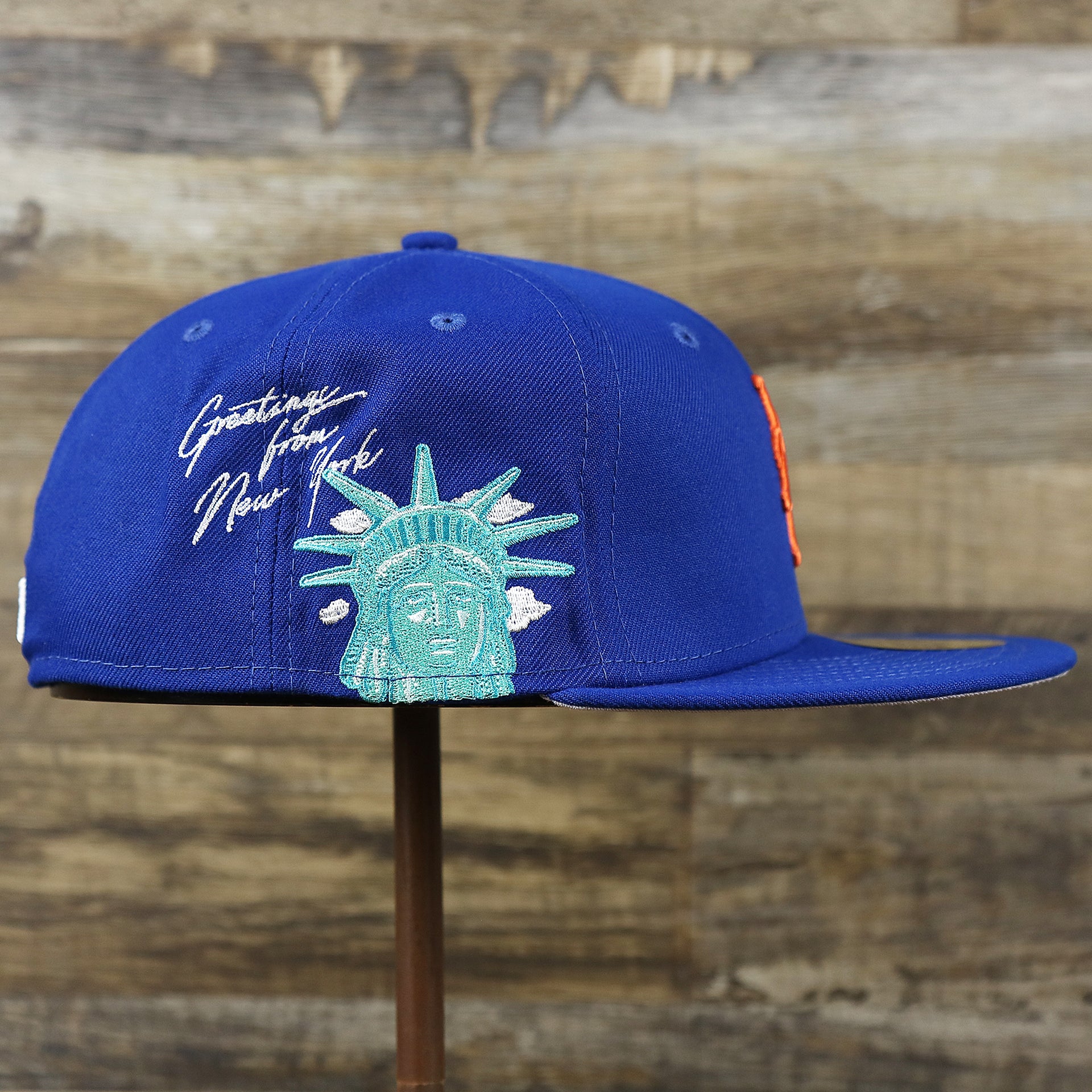 The wearer's right on the New York Mets Lady Liberty Side Patch Gray Bottom 59Fifty Fitted Cap | Royal Blue 59Fifty Cap