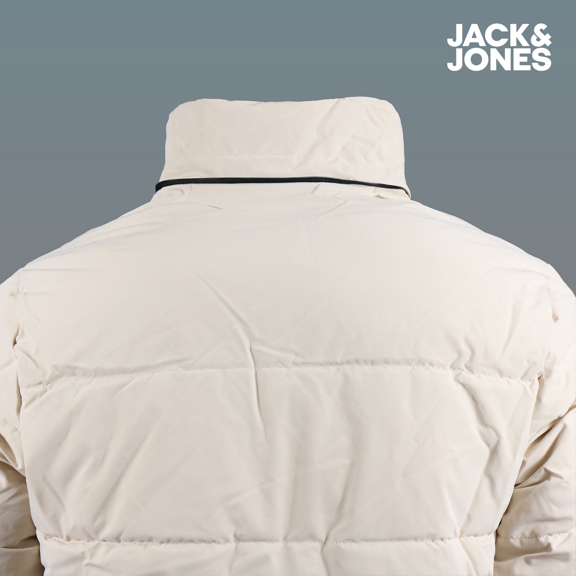 The backside of the Jack And Jones Moonbeam Puffer Jacket With Hidden Pocket | Cream Puffer Jacket without the hood