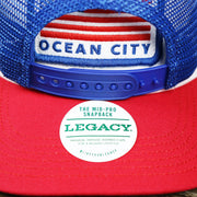 The Legacy Sticker on the Ocean City Stars And Stripes USA Flag Royal Blue Mesh Trucker Hat | White And Royal Blue Trucker Hat