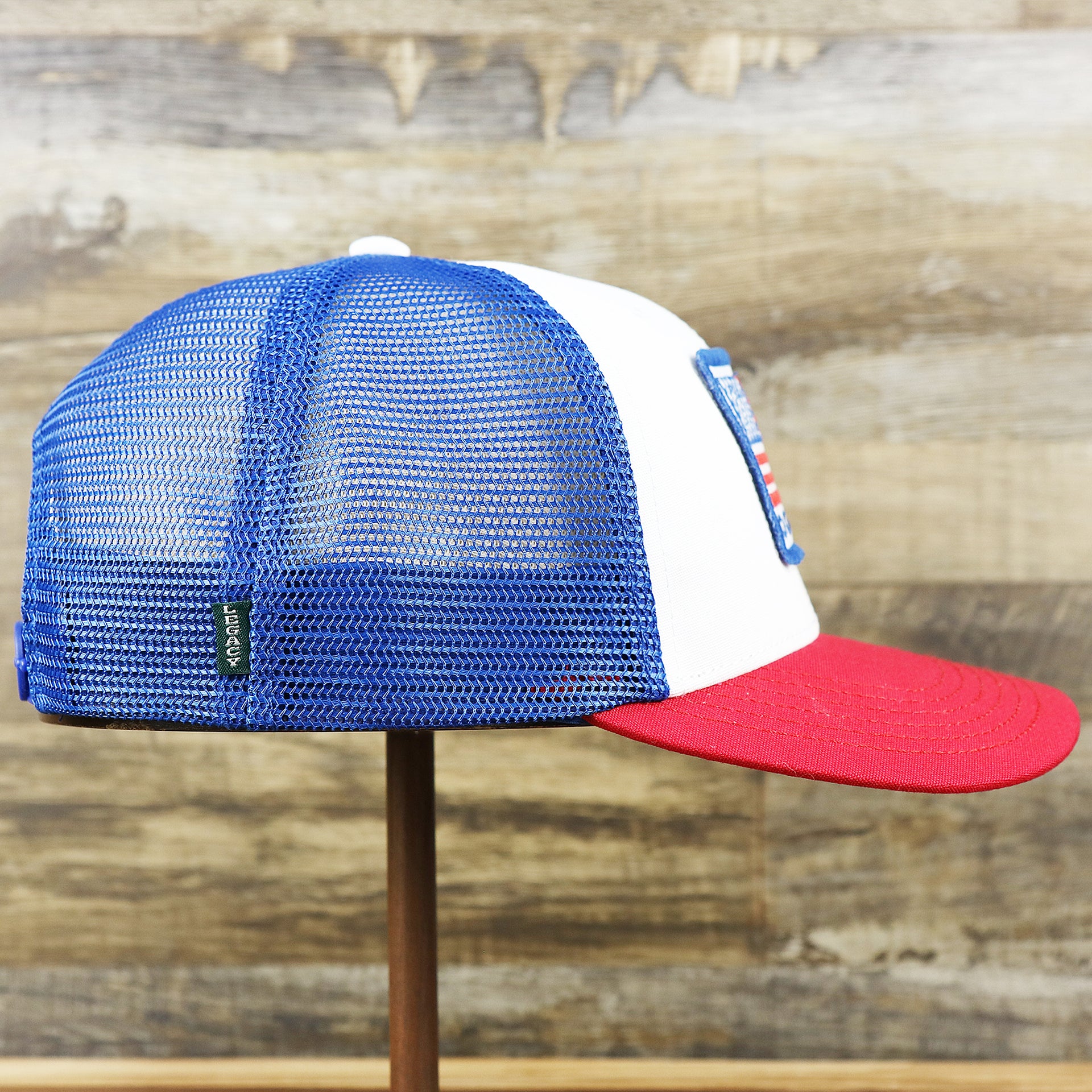 The wearer's right on the Ocean City Stars And Stripes USA Flag Royal Blue Mesh Trucker Hat | White And Royal Blue Trucker Hat