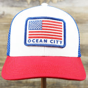 The front of the Ocean City Stars And Stripes USA Flag Royal Blue Mesh Trucker Hat | White And Royal Blue Trucker Hat