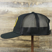 The wearer's left on the Ocean City New Jersey Shark Patch Mesh Back Trucker Hat | Black Mesh Snapback