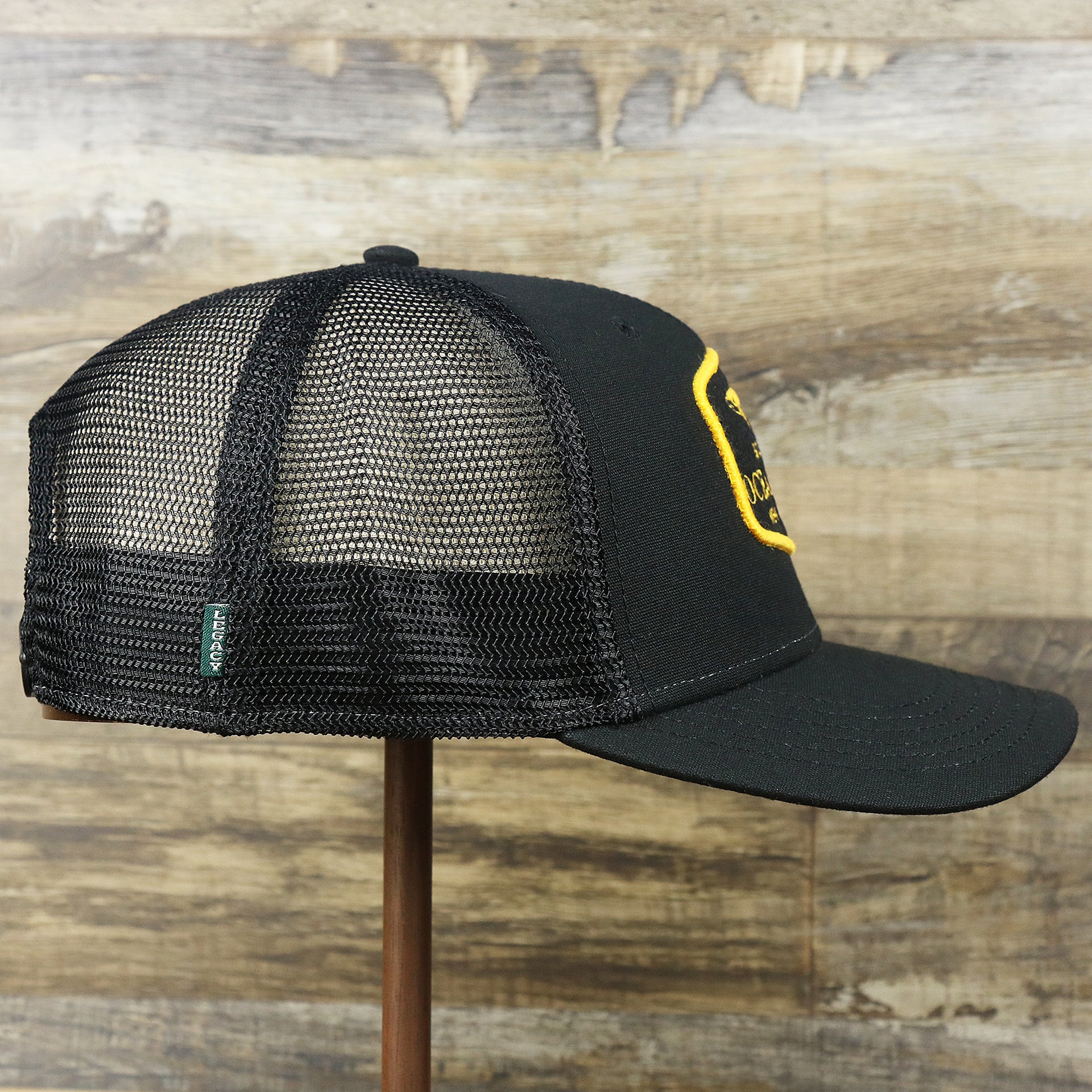 The wearer's right on the Ocean City New Jersey Shark Patch Mesh Back Trucker Hat | Black Mesh Snapback