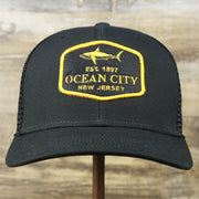 The front of the Ocean City New Jersey Shark Patch Mesh Back Trucker Hat | Black Mesh Snapback