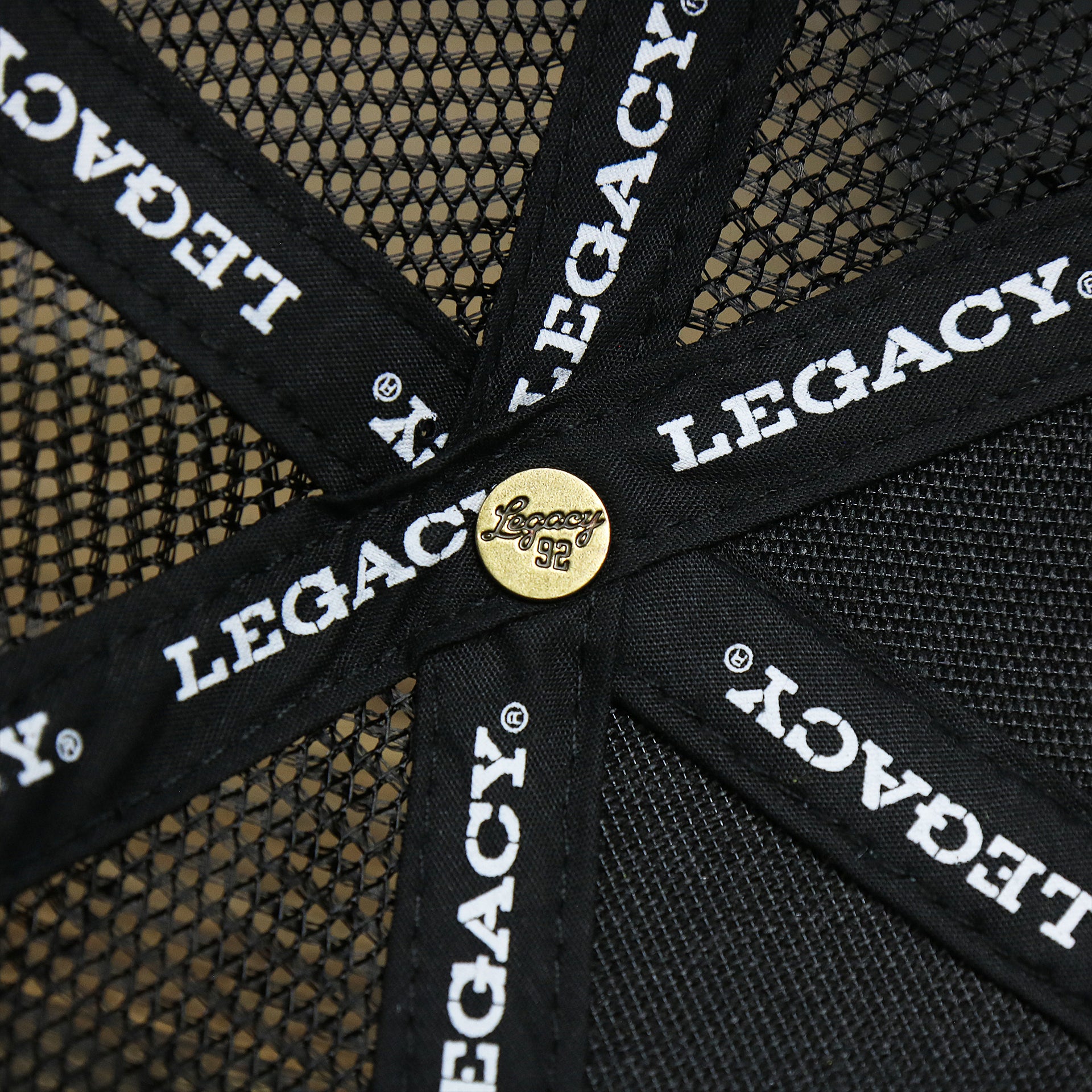 The Legacy Engraved Button on the Ocean City New Jersey Shark Patch Mesh Back Trucker Hat | Black Mesh Snapback