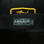 The Legacy Tag on the Ocean City New Jersey Shark Patch Mesh Back Trucker Hat | Black Mesh Snapback