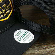 The Legacy Sticker on the Ocean City New Jersey Shark Patch Mesh Back Trucker Hat | Black Mesh Snapback