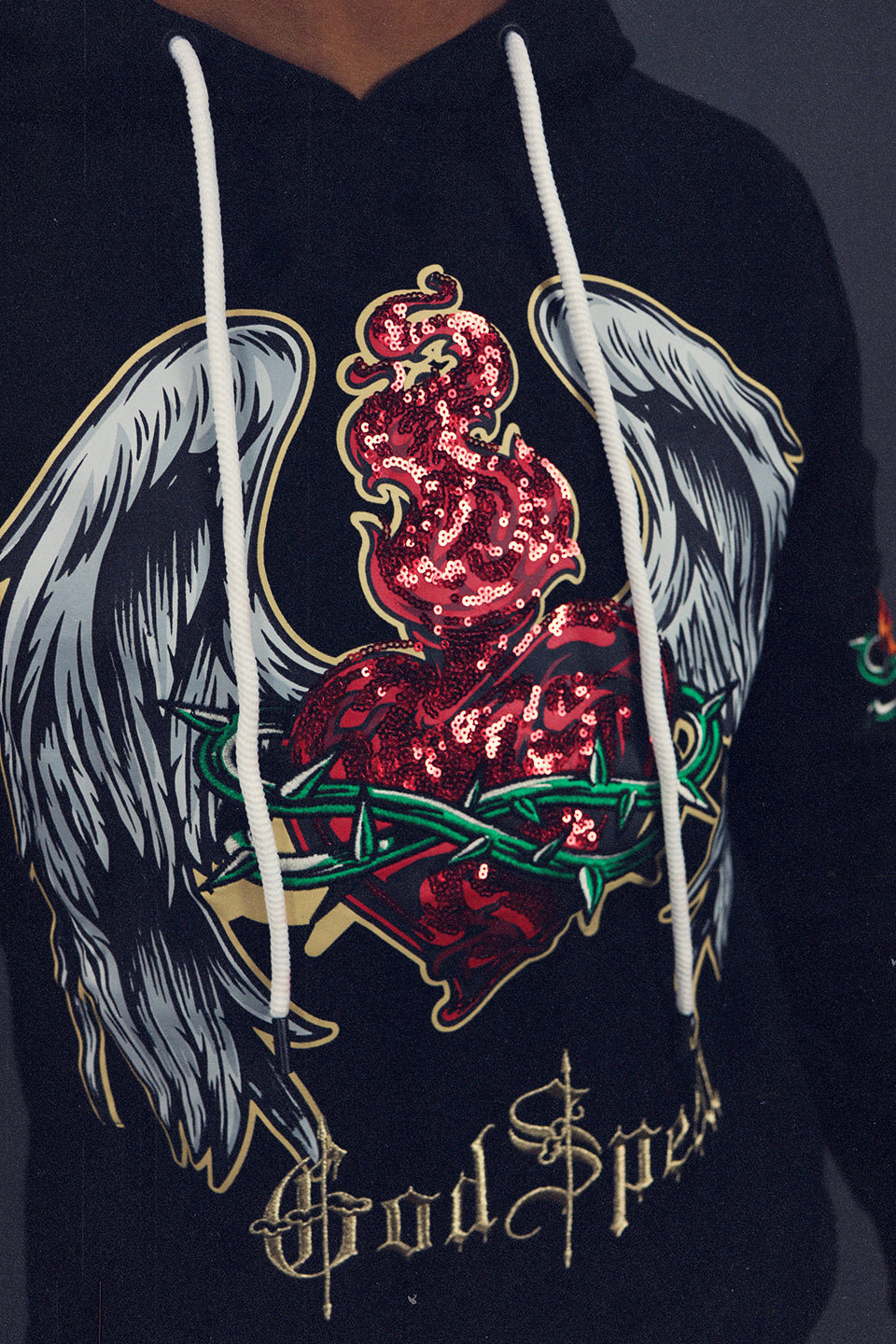 A close up of the Sequin Custom Graphic on the Men's GodSpeed Hype Beast Streetwear Sequin Graphic Pullover Hoodie | Black