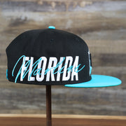 The wearer's right on the Cooperstown Florida Marlins MLB Side Font Green Bottom 9Fifty Snapback Cap | Black Snap Cap