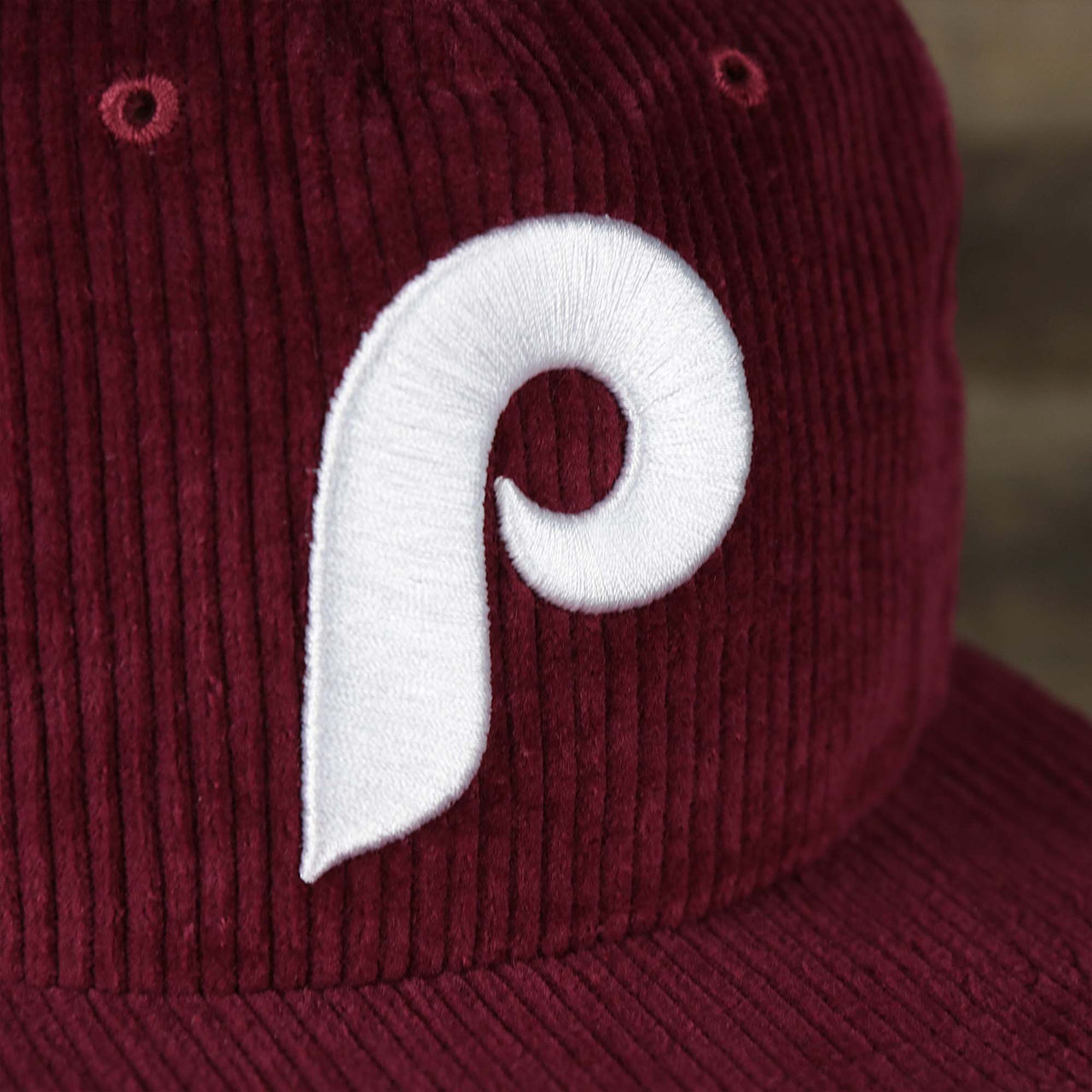 The logo on the Corduroy Philadelphia Phillies Cooperstown Snapback | 47 Brand Dark Maroon