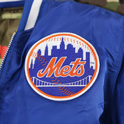 The Mets Alternate Logo on the New York Mets MLB Patch Alpha Industries Reversible Bomber Jacket With Camo Liner | Royal Blue Bomber Jacket