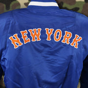 The New York Wordmark on the New York Mets MLB Patch Alpha Industries Reversible Bomber Jacket With Camo Liner | Royal Blue Bomber Jacket