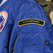 The 2x Champions Patch on the New York Mets MLB Patch Alpha Industries Reversible Bomber Jacket With Camo Liner | Royal Blue Bomber Jacket