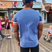 The backside of the New York Mets Wordmark Otis Ringer Tshirt With Orange And White Striped Sleeves | Cadet Blue T-Shirt