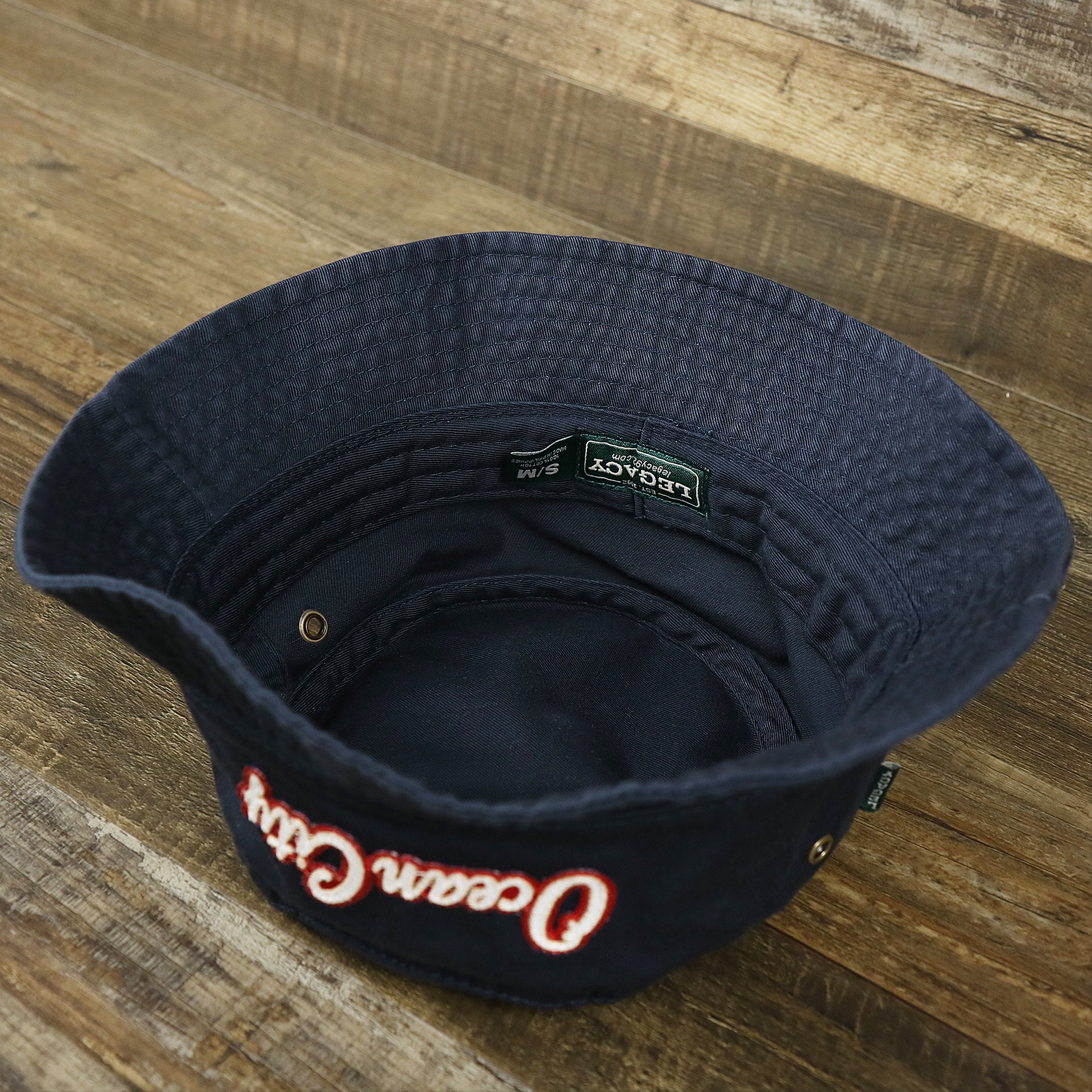 The underside of the White OCNJ Double Wordmark Red Outline Bucket Hat | Navy Bucket Hat