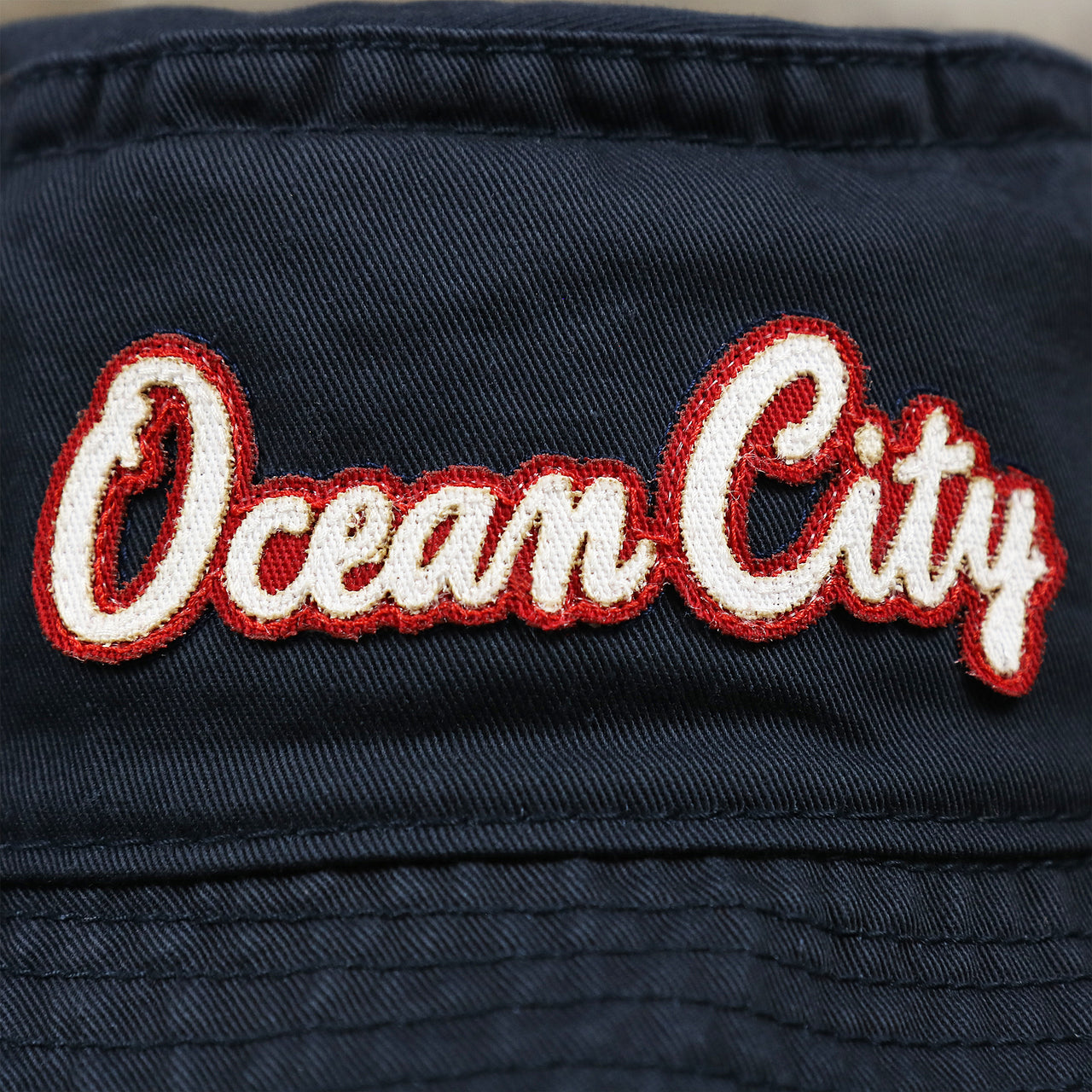 The Ocean City Wordmark on the White OCNJ Double Wordmark Red Outline Bucket Hat | Navy Bucket Hat