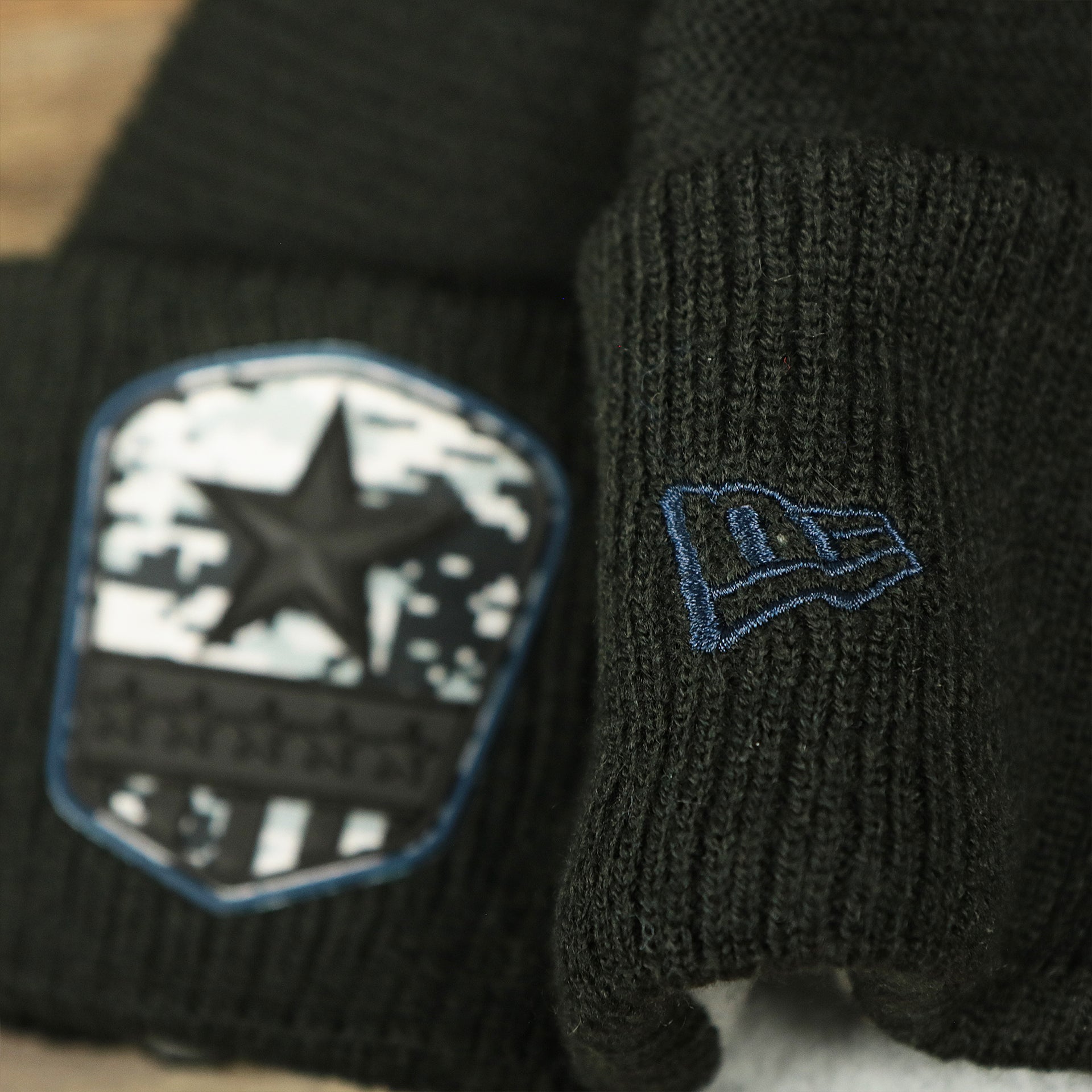 The New Era Logo on the Dallas Cowboys Salute To Service Ribbon Rubber Military Cowboys Patch On Field NFL Beanie | Black Beanie