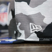 A close up of the New Era Logo on the NFL Logo OnField Summer Training 2022 Camo 9Fifty Snapback | Royal Blue Camo 9Fifty