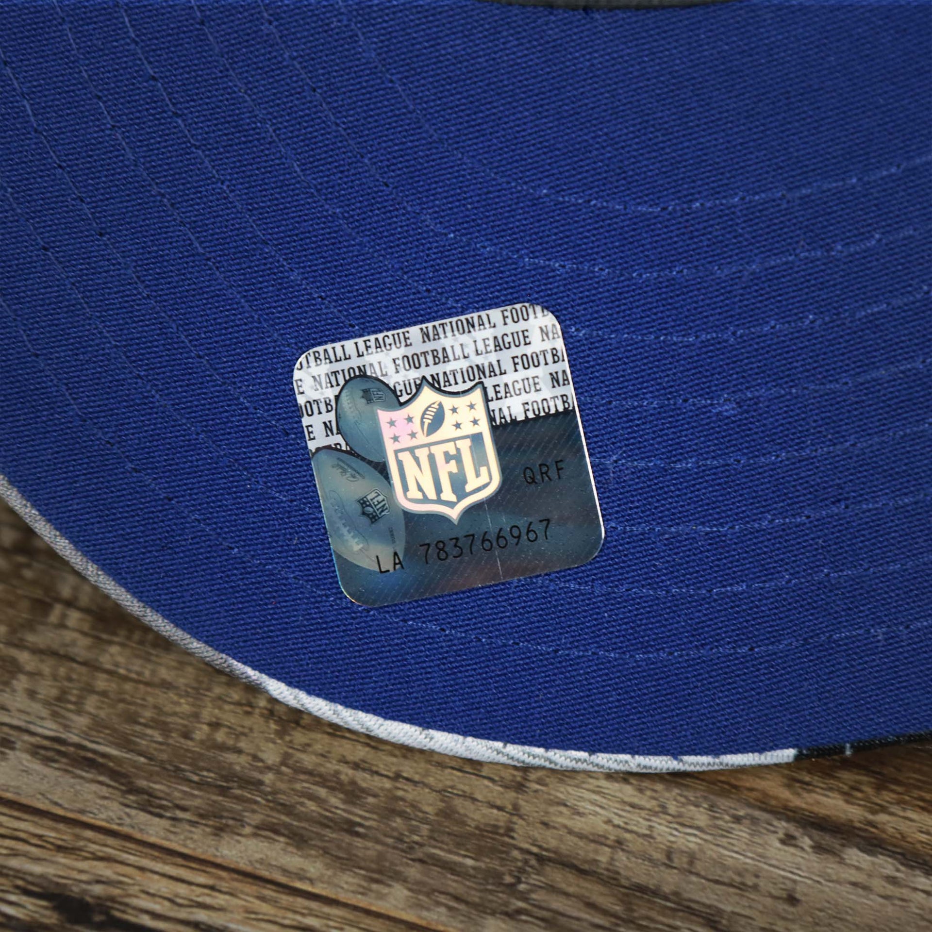 The NFL Sticker on the visor of the NFL Logo OnField Summer Training 2022 Camo 9Fifty Snapback | Royal Blue Camo 9Fifty