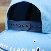 The Blue Adjustable Strap on the North Carolina Tar Heels Team Script Gray Bottom 9Fifty Snapback | Light Blue And Navy Blue Snap Cap